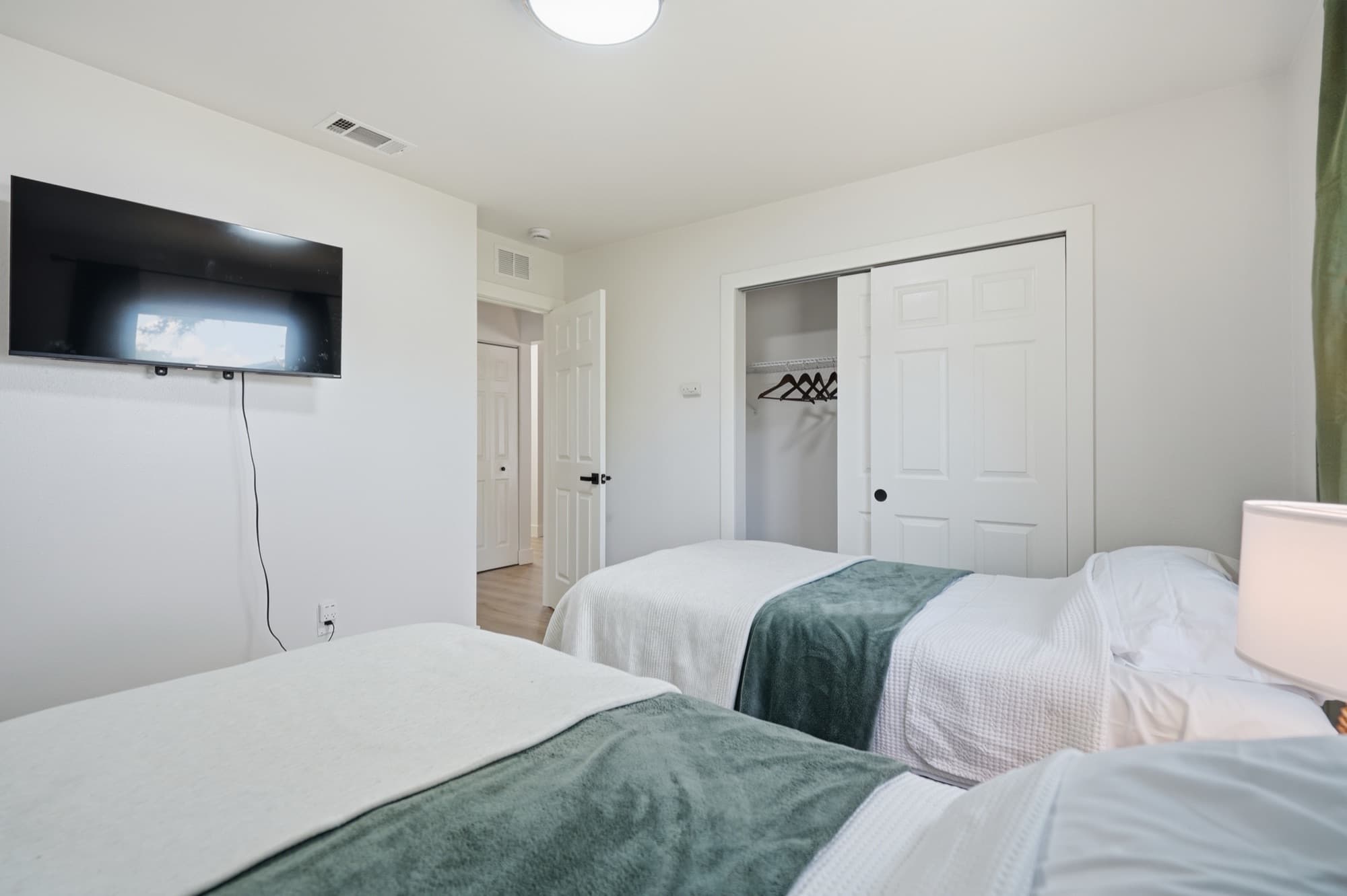 Bedroom 1 with wall-mounted smart TV