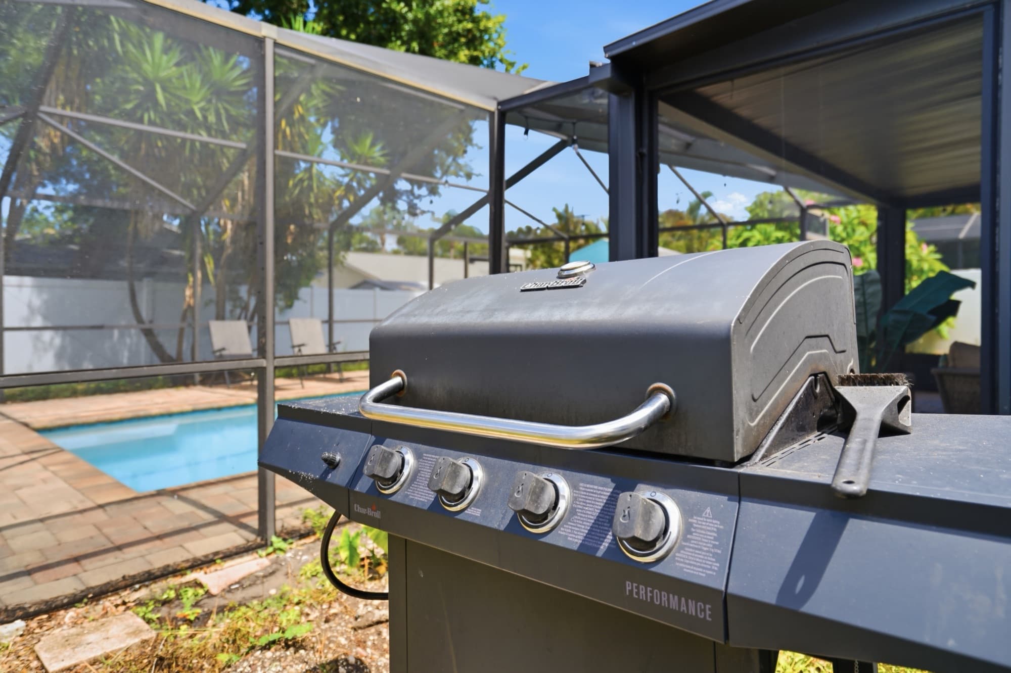 Outdoor gas grill beside the pool