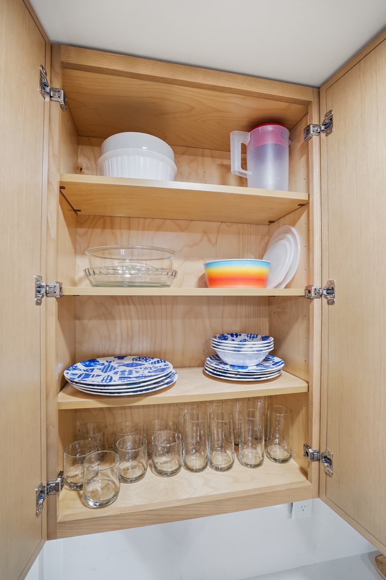 Stocked kitchen cabinets and dishware